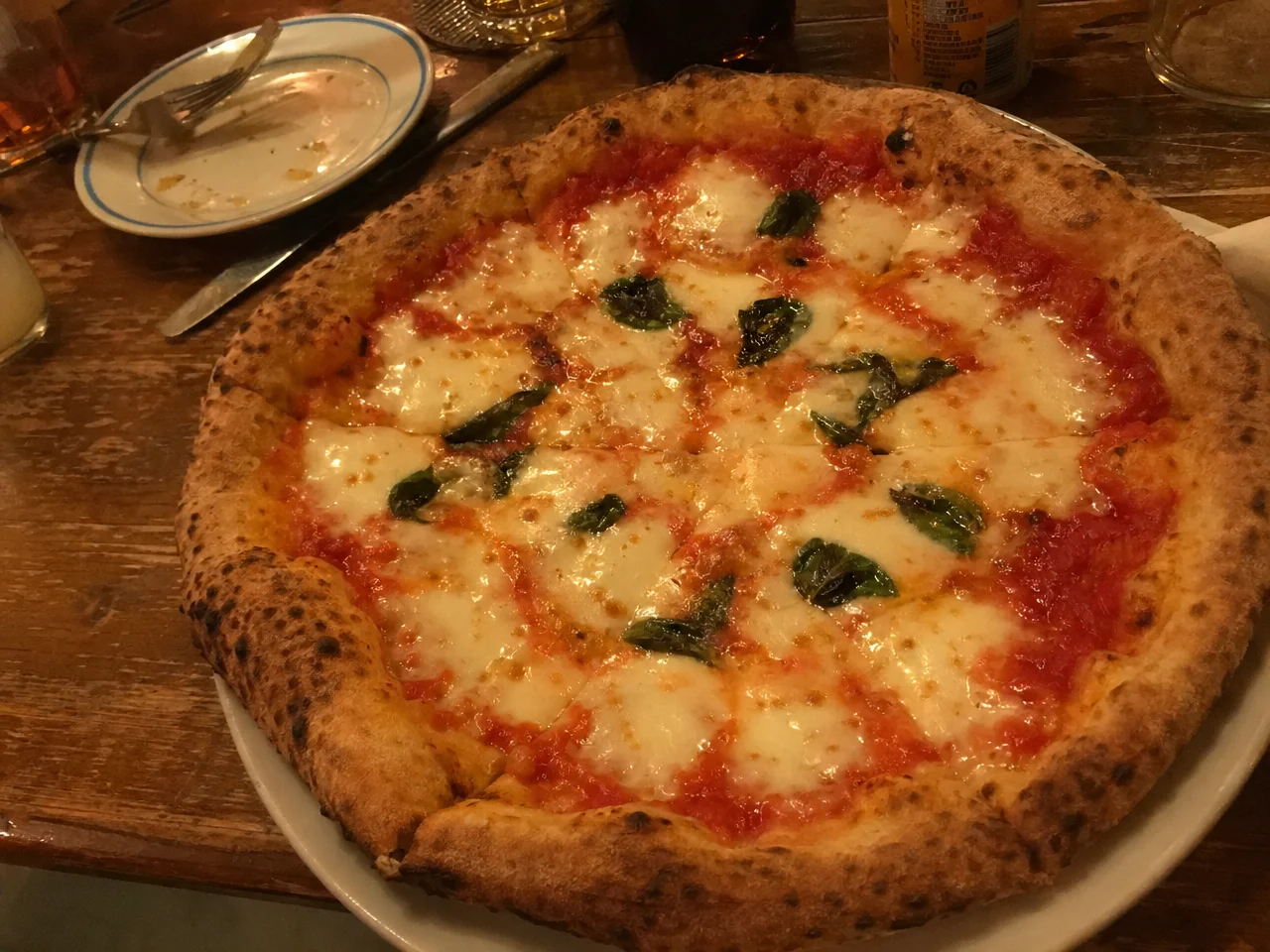 Amateur phone photo of a pizza before AI enhancement